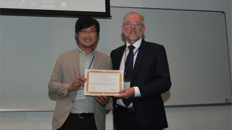 Prof. Anthony Leung (left) receiving the award certificate from Prof. David Toll (right), the Chair of TC106 (Unsaturated Soils)”